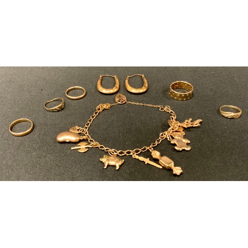 403 - A 9ct gold charm bracelet;  9ct gold rings;  another 14ct gold;  pair of yellow metal hoop earrings,... 