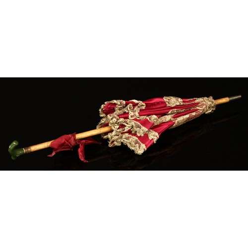 4097 - A late 19th/early 20th century doll's parasol, the wooden shaft mounted with a green enamel handle, ... 