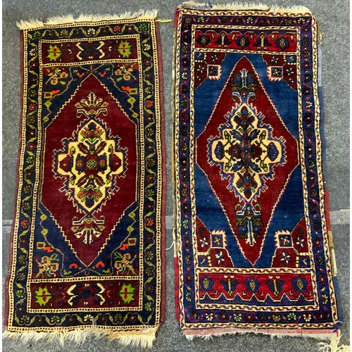 28 - A Turkish wool rug, stylised flowers on a blue and red ground, 116cm long, 55cm wide;  others, 124cm... 