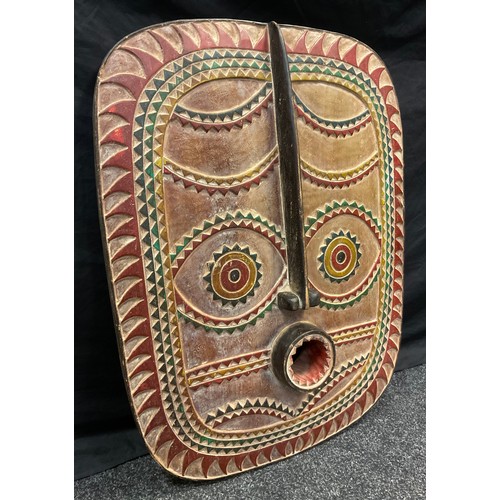 44 - A large Tribal African style carved and painted wood mask, 77cm x 58.5cm.