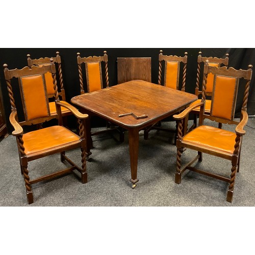 47 - An early 20th century oak dining table and six chairs - comprising extending dining table with singl... 