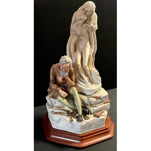 48 - A Capodimonte porcelain figure group, modelled as Michelangelo seated beside a sculpture titled 'Pie... 