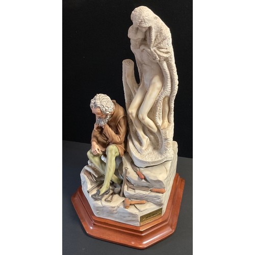 48 - A Capodimonte porcelain figure group, modelled as Michelangelo seated beside a sculpture titled 'Pie... 