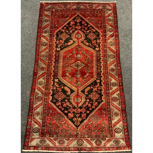 49 - A North-West Persian Zanjan rug / carpet, knotted in tones of deep red, black, and pale grey, 232cm ... 