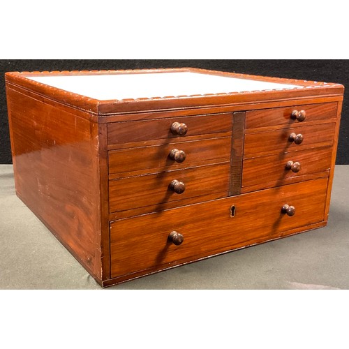 54 - A mahogany Dentists pharmaceutical  table-top chest, having an arrangement of seven graduated drawer... 