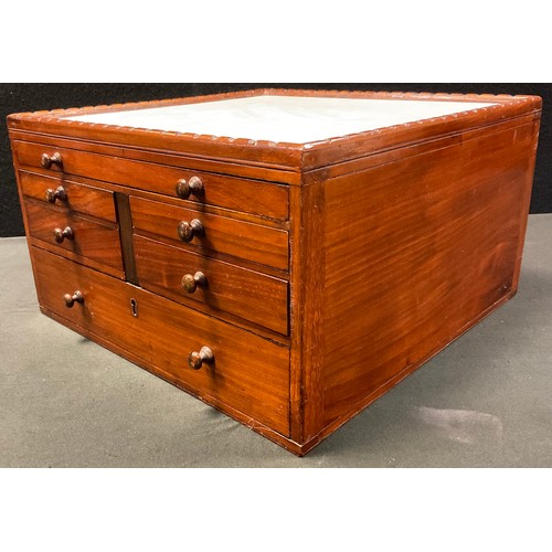 54 - A mahogany Dentists pharmaceutical  table-top chest, having an arrangement of seven graduated drawer... 