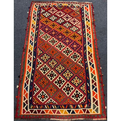 61 - A South-West Persian Qashgai Kilim rug / carpet, knotted with stylised geometric motifs in vibrant c... 