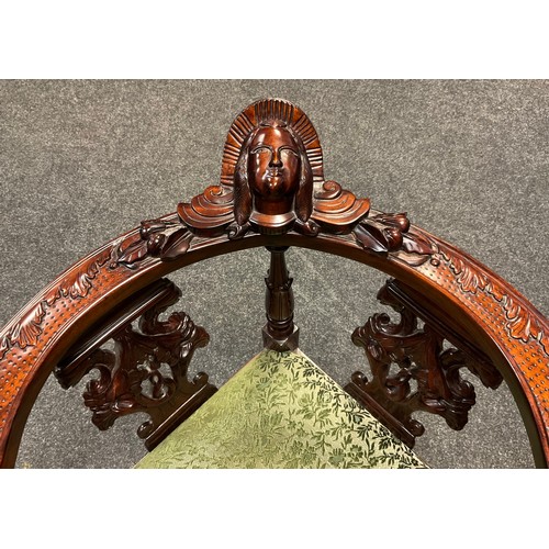 87 - A reproduction Italian Renaissance Revival carved mahogany corner chair, mask head top rail, carved ... 