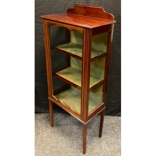 103 - An Edwardian mahogany Vitrine / display cabinet, single glazed door enclosing two tiers of shelving,... 