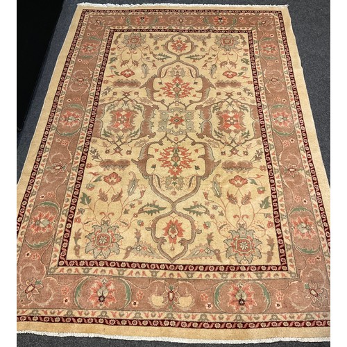 252 - A Persian Heriz silk and wool rug / carpet, knotted in subtle tones of brown, cream, and coral, with... 