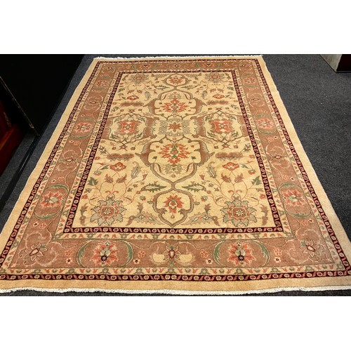 252 - A Persian Heriz silk and wool rug / carpet, knotted in subtle tones of brown, cream, and coral, with... 