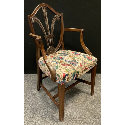 273 - A 19th century walnut, shield-back open arm chair, fleur-de-lys splat, stuffed-over seat, tapering s... 