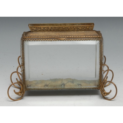 35 - A French gilt metal circular dressing table box,  shaped handle, the glazed lid set with lace and si... 