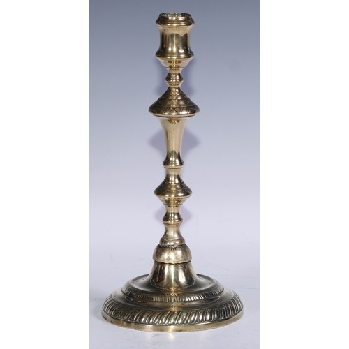 49 - A pair of George II/early George III brass candlesticks, of seamed construction, knopped pillars, ga... 