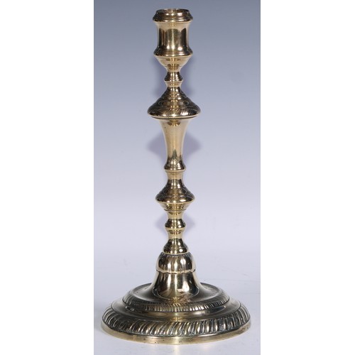 49 - A pair of George II/early George III brass candlesticks, of seamed construction, knopped pillars, ga... 