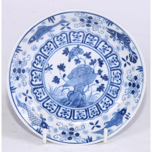 64 - A pair of Chinese circular dishes, painted in tones of underglaze blue with flowers and rocks, withi... 