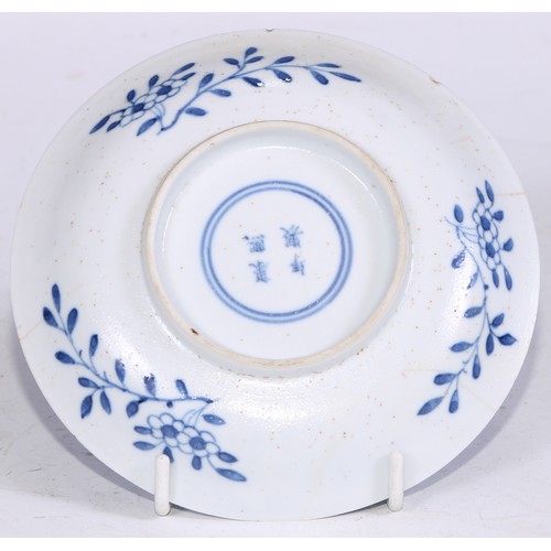 64 - A pair of Chinese circular dishes, painted in tones of underglaze blue with flowers and rocks, withi... 