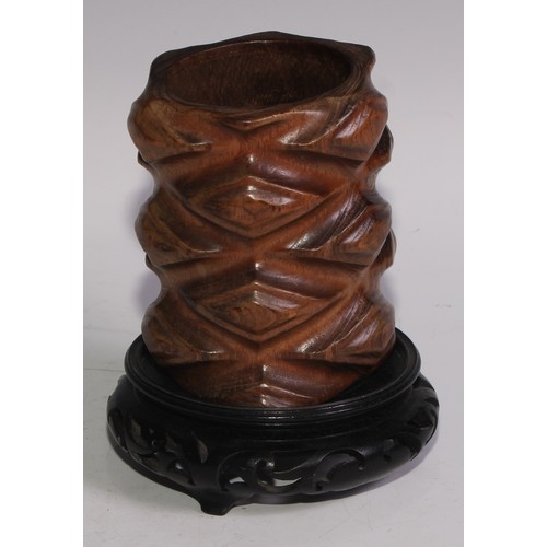 78 - A Chinese hardwood brush pot, carved in the rustic manner, 10.5cm high, pierced stand