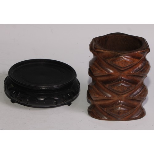 78 - A Chinese hardwood brush pot, carved in the rustic manner, 10.5cm high, pierced stand