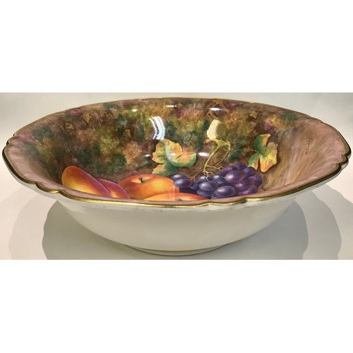 87 - A Royal Worcester shaped circular bowl, painted with still life fruit, signed M. Tandy, 25cm diamete... 