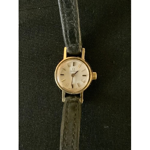 412 - A lady's 9ct gold Omega wristwatch, baton numbers, leather strap, c.1960