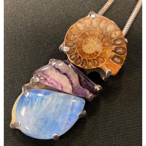 383 - An unusual Ammonite fossil. blue john and blue moonstone pendant necklace, 925 silver mount and snak... 