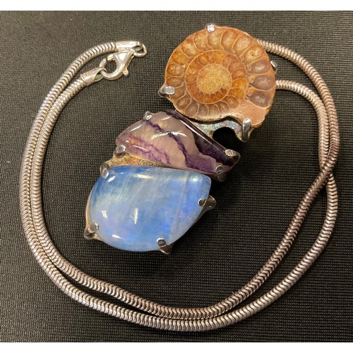 383 - An unusual Ammonite fossil. blue john and blue moonstone pendant necklace, 925 silver mount and snak... 