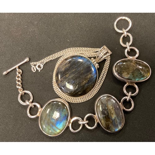 384 - A 925 silver and labradorite triple oval cabochon panel bracelet, t-Bar and loop clasp, 20cm long, C... 