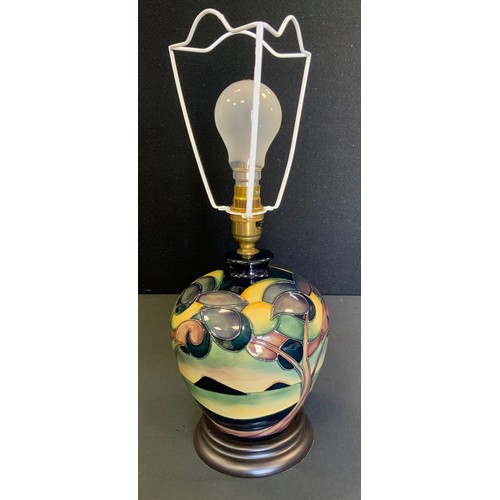 38 - A Moorcroft Western Isles pattern compressed ovoid table lamp, designed by Sian Leaper, wooden base,... 