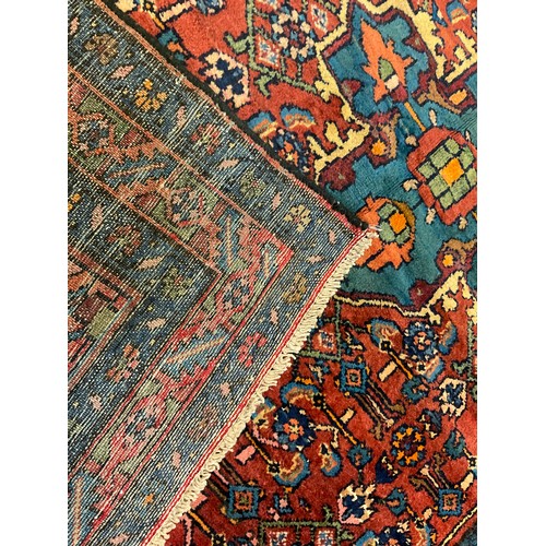 48 - A Farahan rug / carpet, hand knotted in deep shades of red and blue with quatrefoil medallion in a f... 