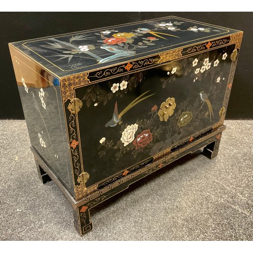 54 - A Chinoiserie black lacquered cabinet on stand, decorated with flowers and fanciful birds, 71.5cm ta... 