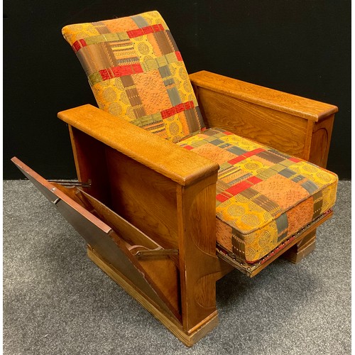 63 - A 1930s Art Deco (possibly Heal’s) oak reclining arm book chair, each arm opening with fall sides, s... 