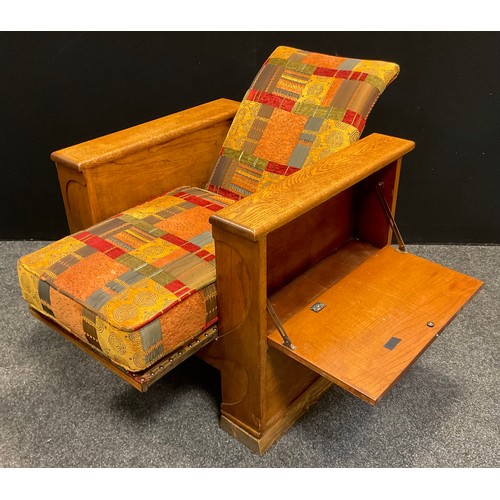 63 - A 1930s Art Deco (possibly Heal’s) oak reclining arm book chair, each arm opening with fall sides, s... 