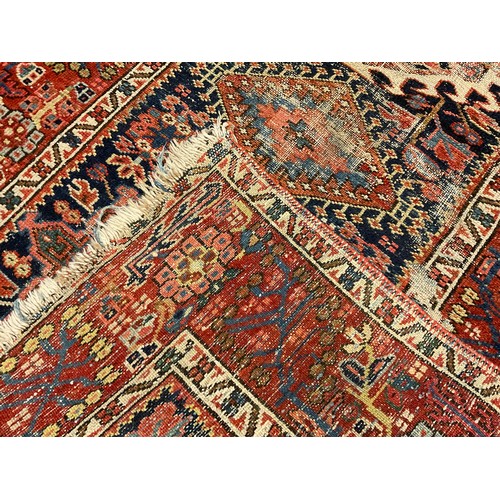 121 - A Middle Eastern woollen runner, in tones of red, blue and cream, 100cm wide, 280cm long