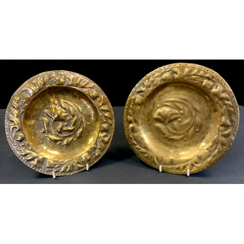 171 - A pair of 19th century Arts & Crafts hammered brass Alms plates, embossed leaf and floral decoration... 