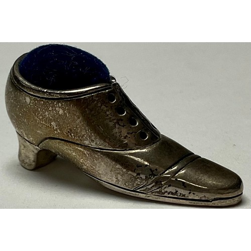 57 - A sterling silver miniature pincushion shoe, marked 925, 4cm long, 2cm high, 12g