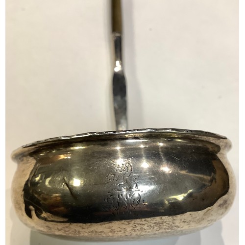 58 - A Georgian silver toddy ladle, bearing a crest, baleen handle, 34cm long