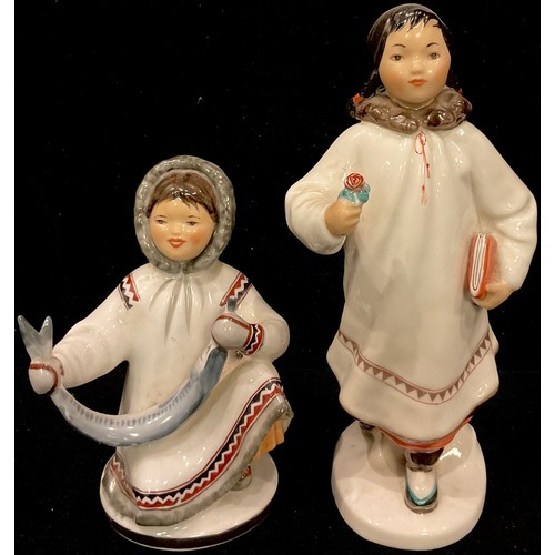 65 - A pair of Russian Lomonosov porcelain Inuit figures, printed marks in red, the tallest 20.5cm