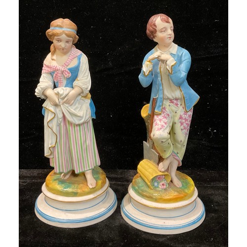 68 - A pair of 19th century French bisque figures, of a young gentleman gardener and companion, 25cm high