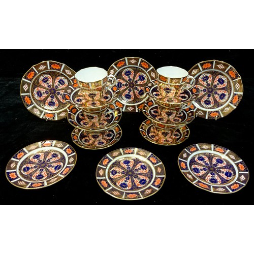 73 - A set of six Royal Crown Derby Imari palette 1128 pattern teacups and saucers, a set of three 1128 t... 