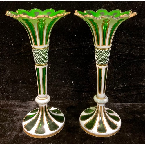 74 - A pair of 19th century Bohemian green flashed glass trumpet vases, shaped cut rim, formerly lustres,... 