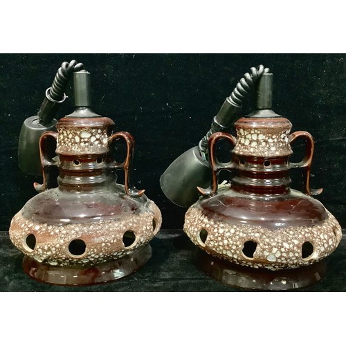 90 - A pair of 1970s German lava ceiling lamps, in brown and white, pierced shades, adjustable hanging he... 