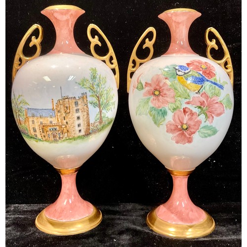 114 - A pair of two-handled pedestal vases, each painted with blue tit amongst flowers and country house, ... 