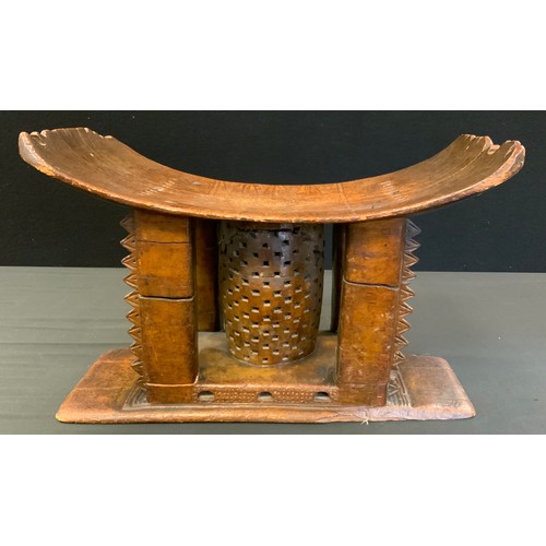 717 - Tribal Art - a 19th century Ashanti stool or seat, arched rectangular seat with four carved supports... 