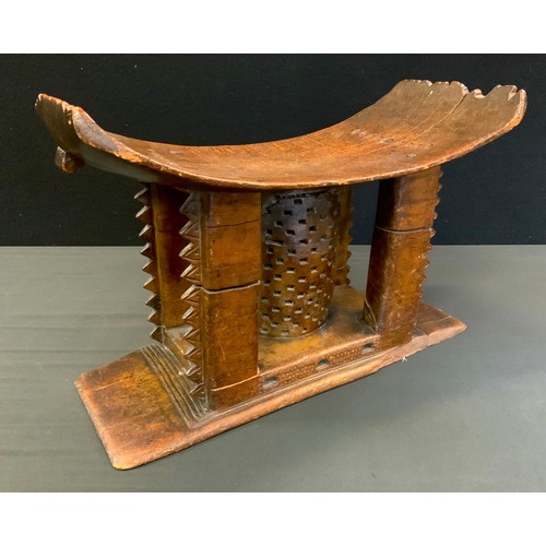 717 - Tribal Art - a 19th century Ashanti stool or seat, arched rectangular seat with four carved supports... 