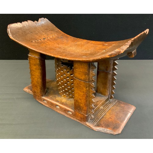 717 - Tribal Art - a 19th century Ashanti stool or seat, arched rectangular seat with four carved supports... 