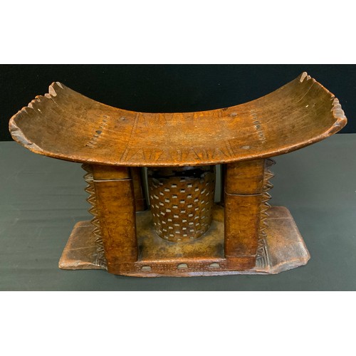 717 - Tribal Art - a 19th century Ashanti stool or seat, arched rectangular seat with four carved supports... 