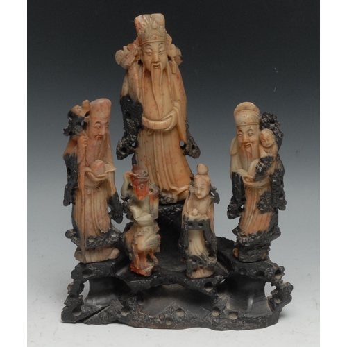 302 - A Chinese soapstone figure group, comprising five carved Immortals on an openwork rocky outcrop,  27... 