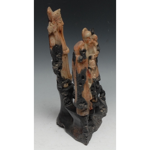 302 - A Chinese soapstone figure group, comprising five carved Immortals on an openwork rocky outcrop,  27... 