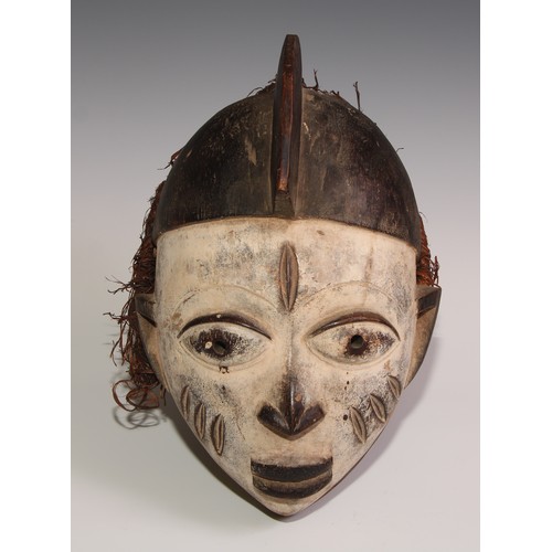 707 - Decorative Tribal Art and the Eclectic Interior - a Baule mask, lofty stylised coiffure, scarified f... 